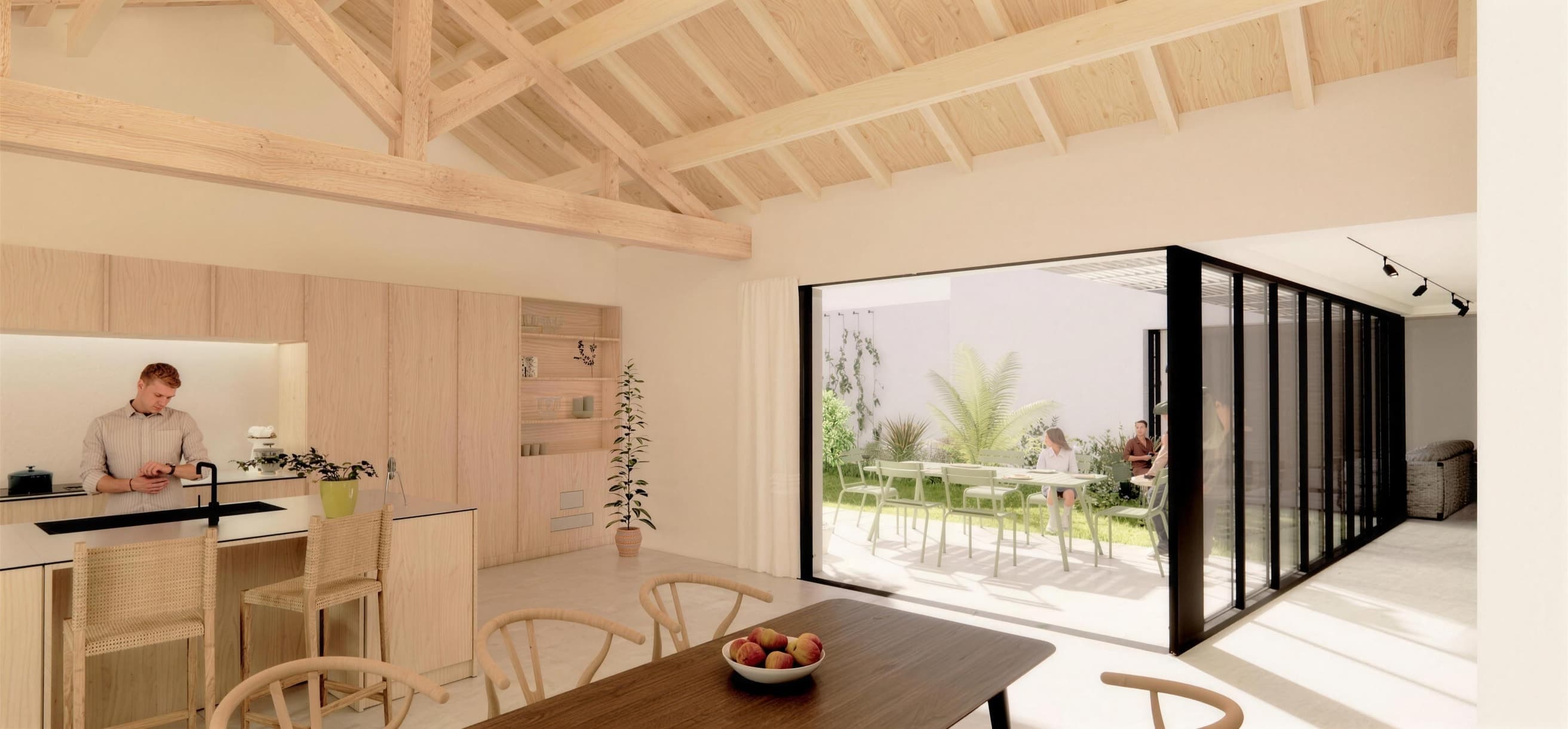 Loft N°02 — salle à manger ouverte sur terrasse arborée, garage indépendant.